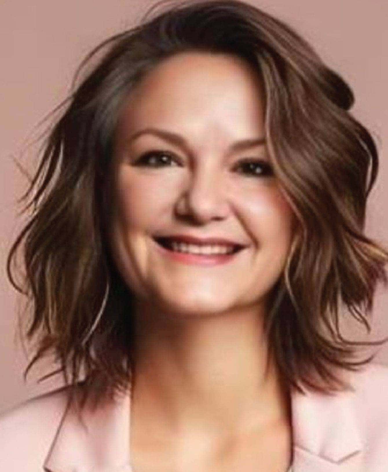 A woman with short brown hair wearing a pink jacket.